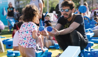Father playing with child at pop-up play event in Tel Aviv