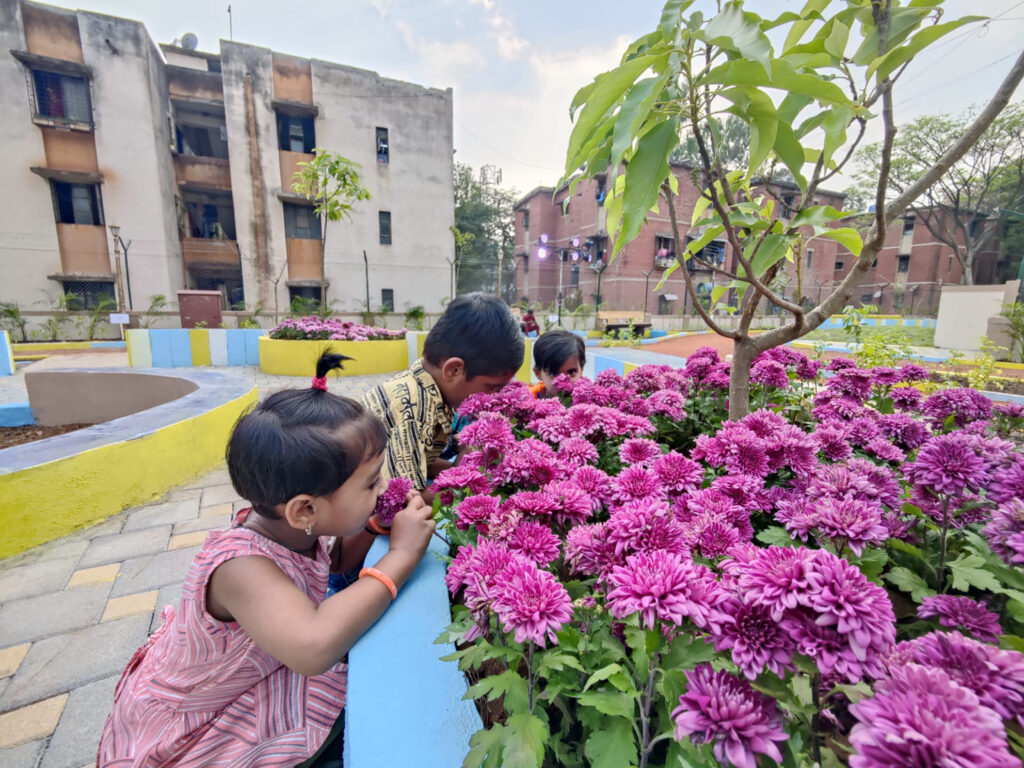 Children enjoying a moment of sensory play in the garden in Pune